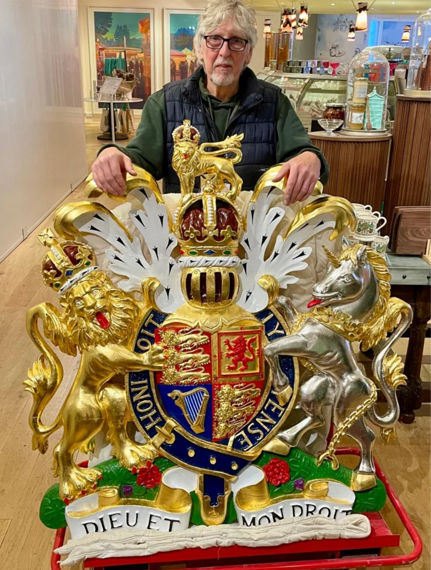 Colin Mullins with the King's Coat of Arms inside Fortnum and Mason before installation